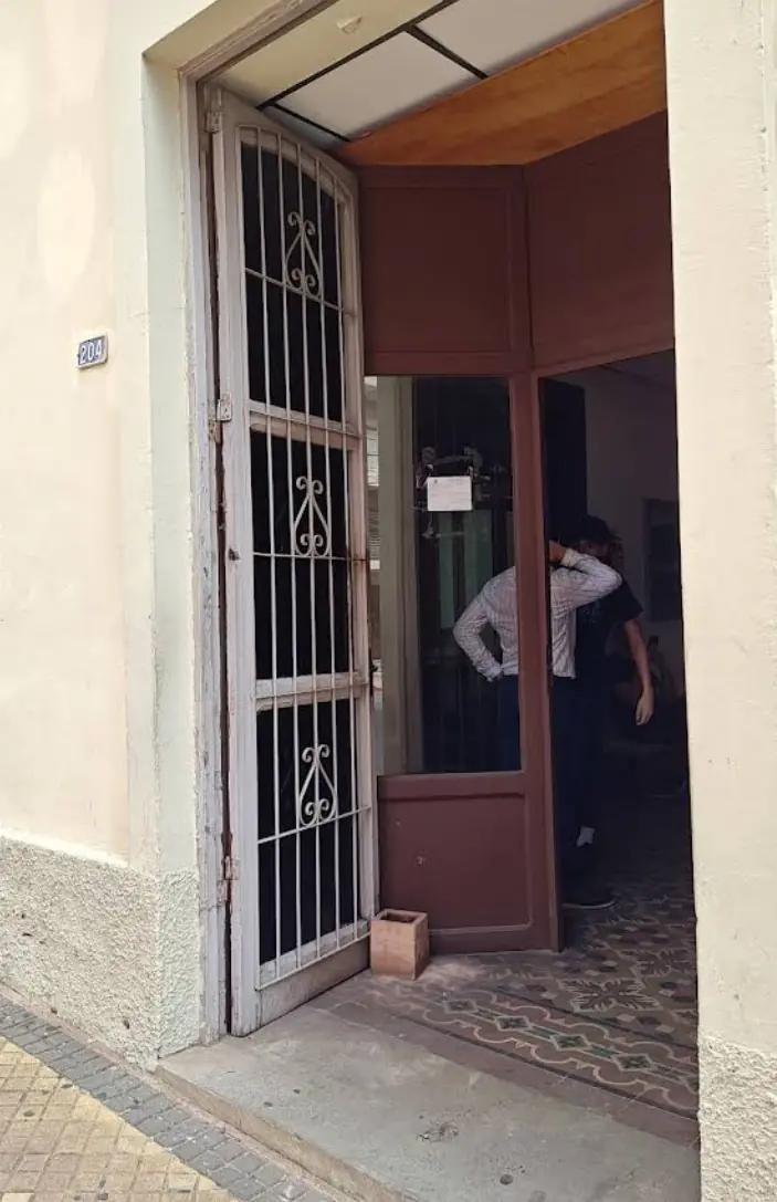 Doorway of Escribanía Vicente Gadea on Caballero 204 — the notary office directly across from Migraciones